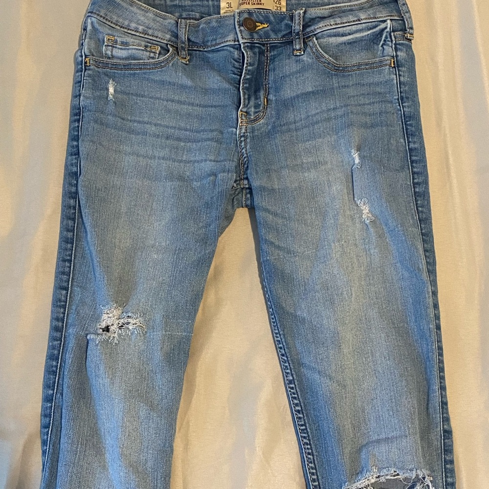 Blue low rise skinny Hollister jeans, with light rips, size 3L, good condition